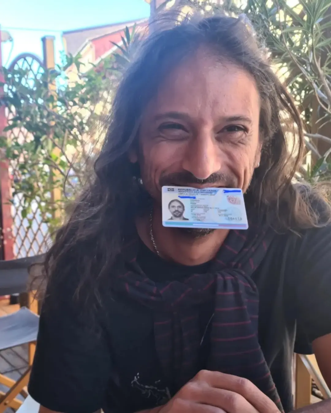 Cliente de Speranza sonriendo con el documento de identidad italiano