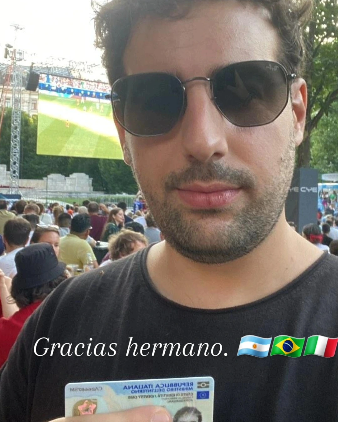 Cliente de Speranza celebrando en un evento al aire libre, con el documento de identidad italiano recién emitido